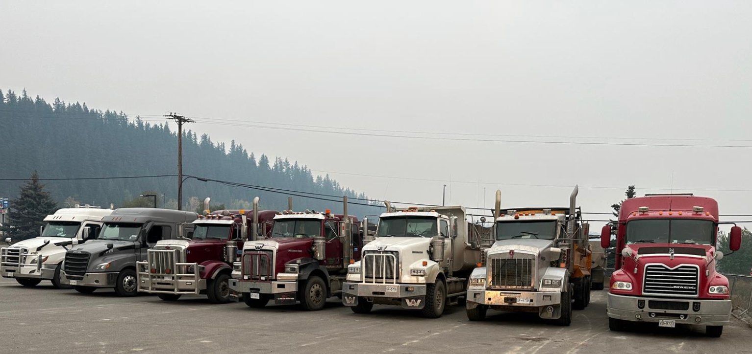 Insta Trucking Ltd fleet of Tri-Drive dump trucks Northern BC